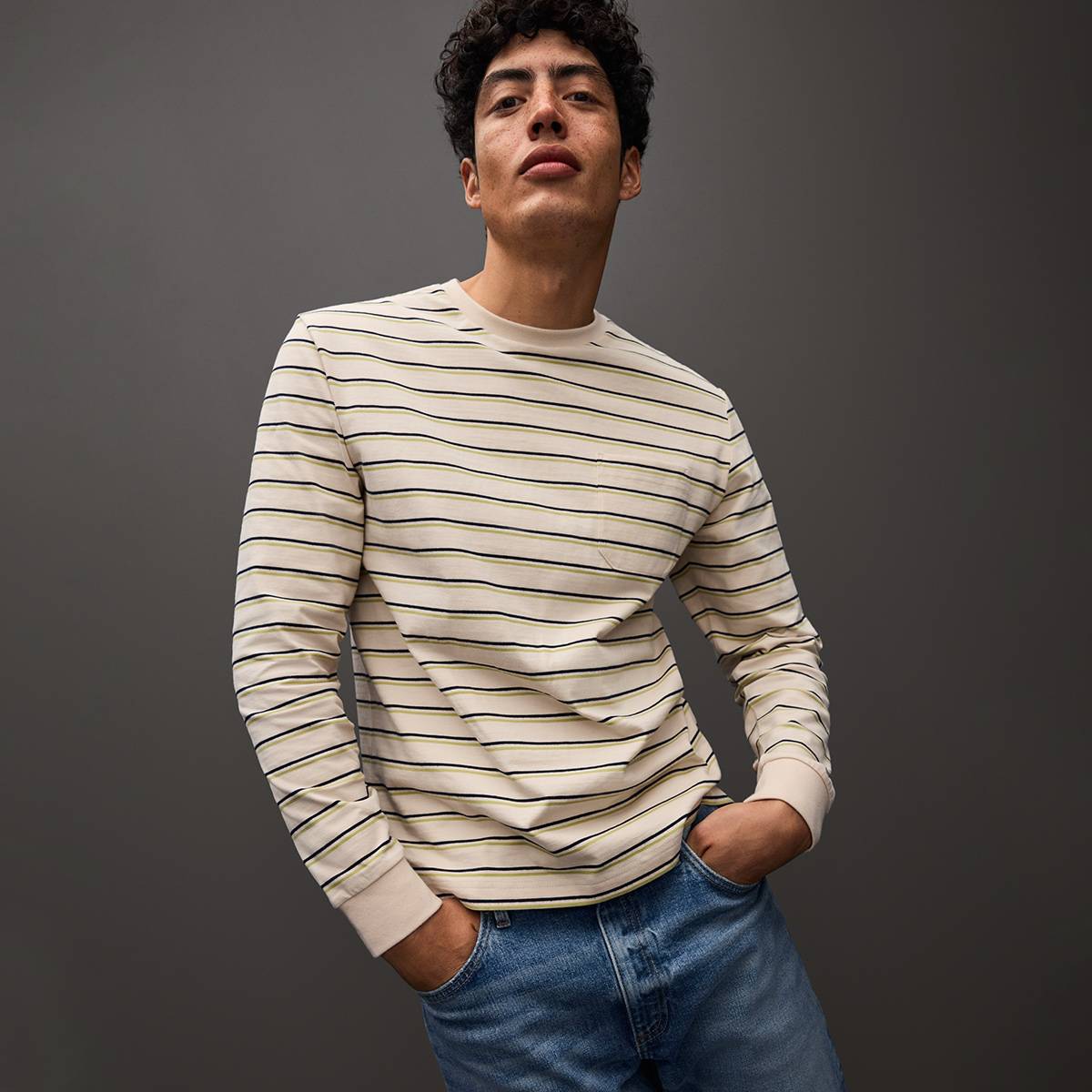  Man wearing stripe top and blue jeans 